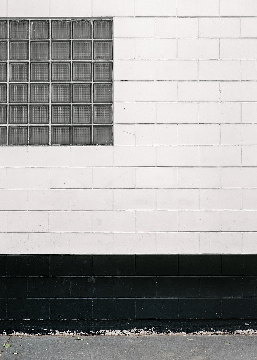 Minimalist Black and White Brick Wall with Glass Block Window