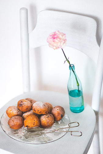 Homemade doughnuts on white chair with blue bottle