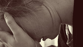 Close-up of woman holding head in despair and grief