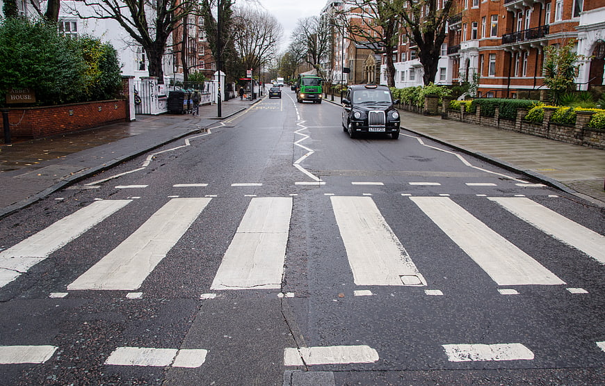Abbey Road Zebra Crossing in London with Black Taxi