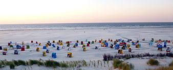 Colorful Beach Huts on Sandy Shore at Dusk