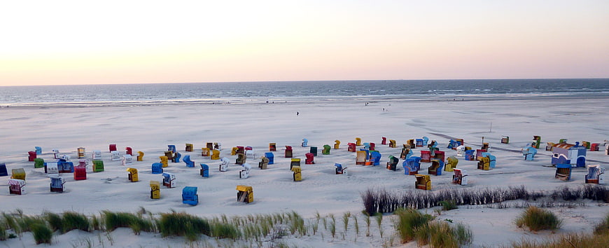 Colorful Beach Huts on Sandy Shore at Dusk