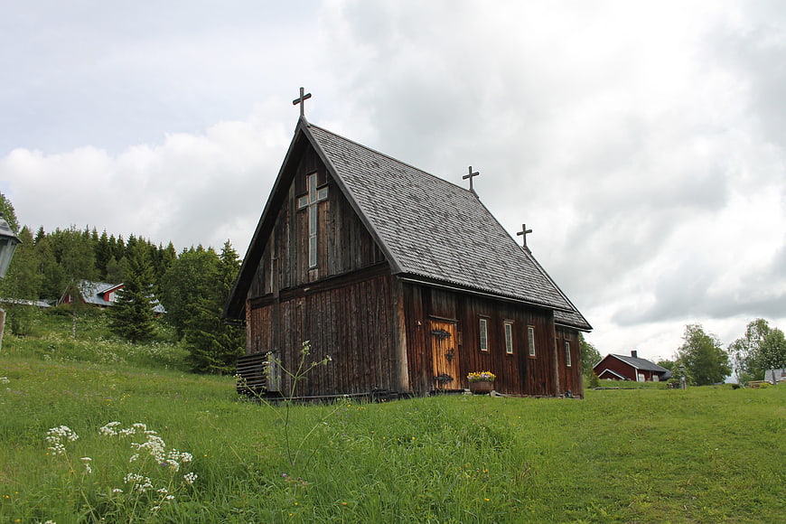 Rustic wooden church in green countryside