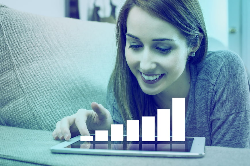 Smiling Businesswoman Analyzing Financial Growth Chart On Tablet