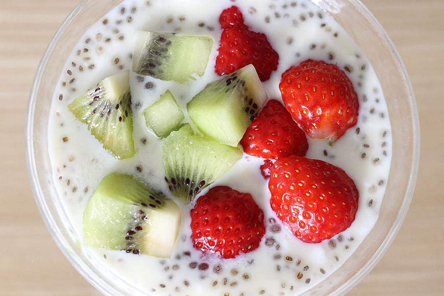 Overhead view of chia seed yogurt bowl with fresh strawberries and kiwi
