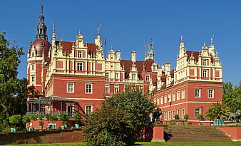 Majestic Red Baroque Palace with Ornate Facade and Gardens