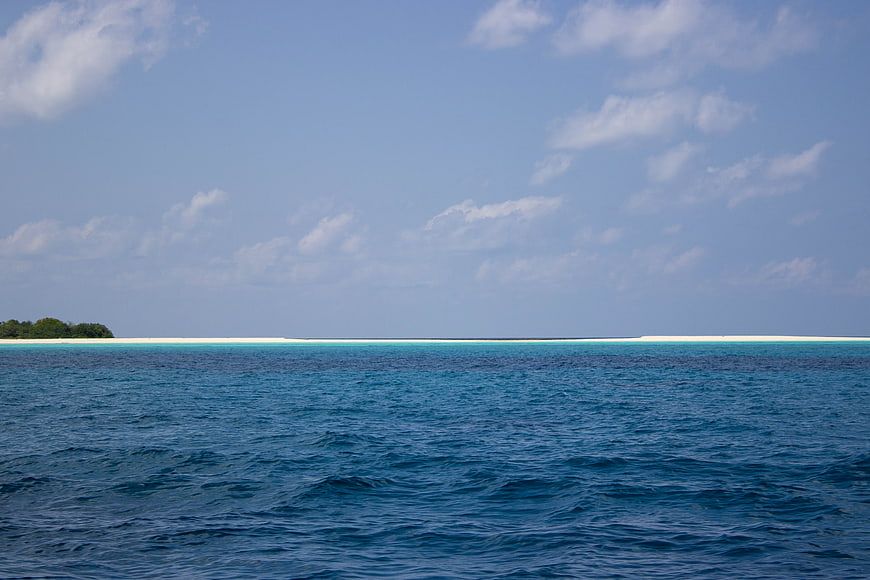 Tropical island with turquoise water and blue sky