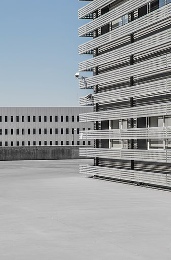 Modern Perforated Metal Building Facade with Concrete Foreground