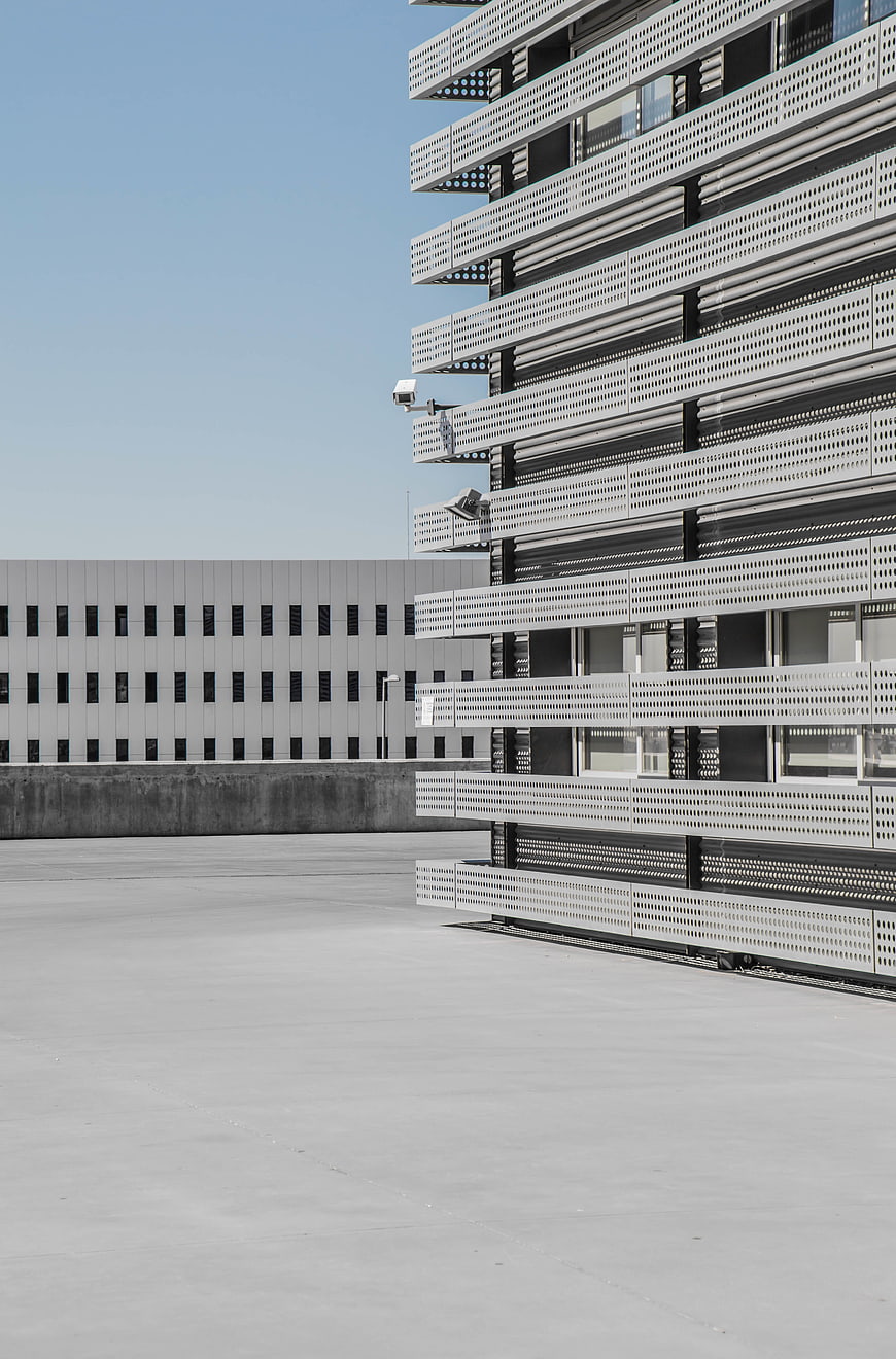 Modern Perforated Metal Building Facade with Concrete Foreground