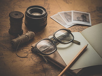 Vintage travel planning with map, camera lens, and notebook