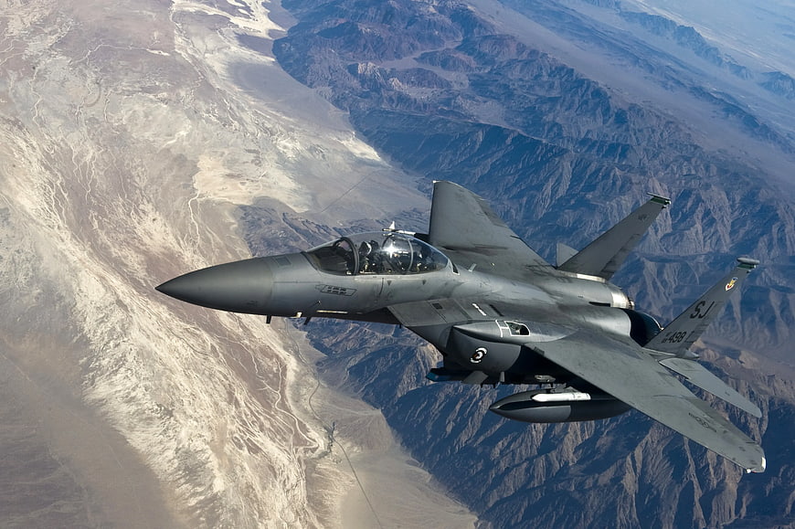 F-16 Fighting Falcon Jet Fighter Flying Over Desert Mountains