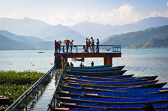 Blue Boats Docked at Fewa Lake with Mountains