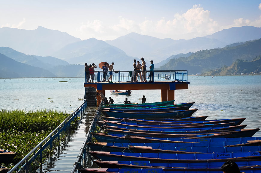 Blue Boats Docked at Fewa Lake with Mountains