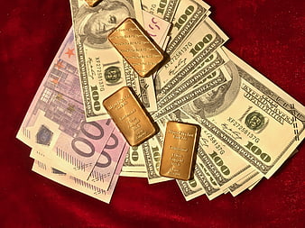 Gold Bars on US Dollars and Euro Banknotes