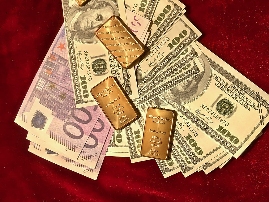Gold Bars on US Dollars and Euro Banknotes