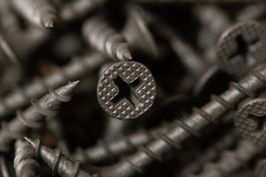 Macro Close-Up of Metal Screws with Cross Head