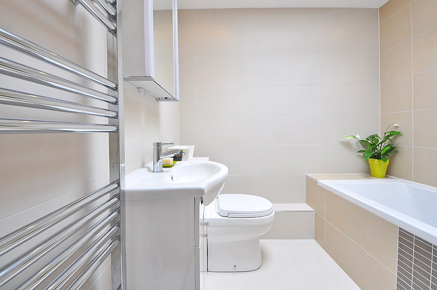 Modern beige bathroom interior with bathtub and sink