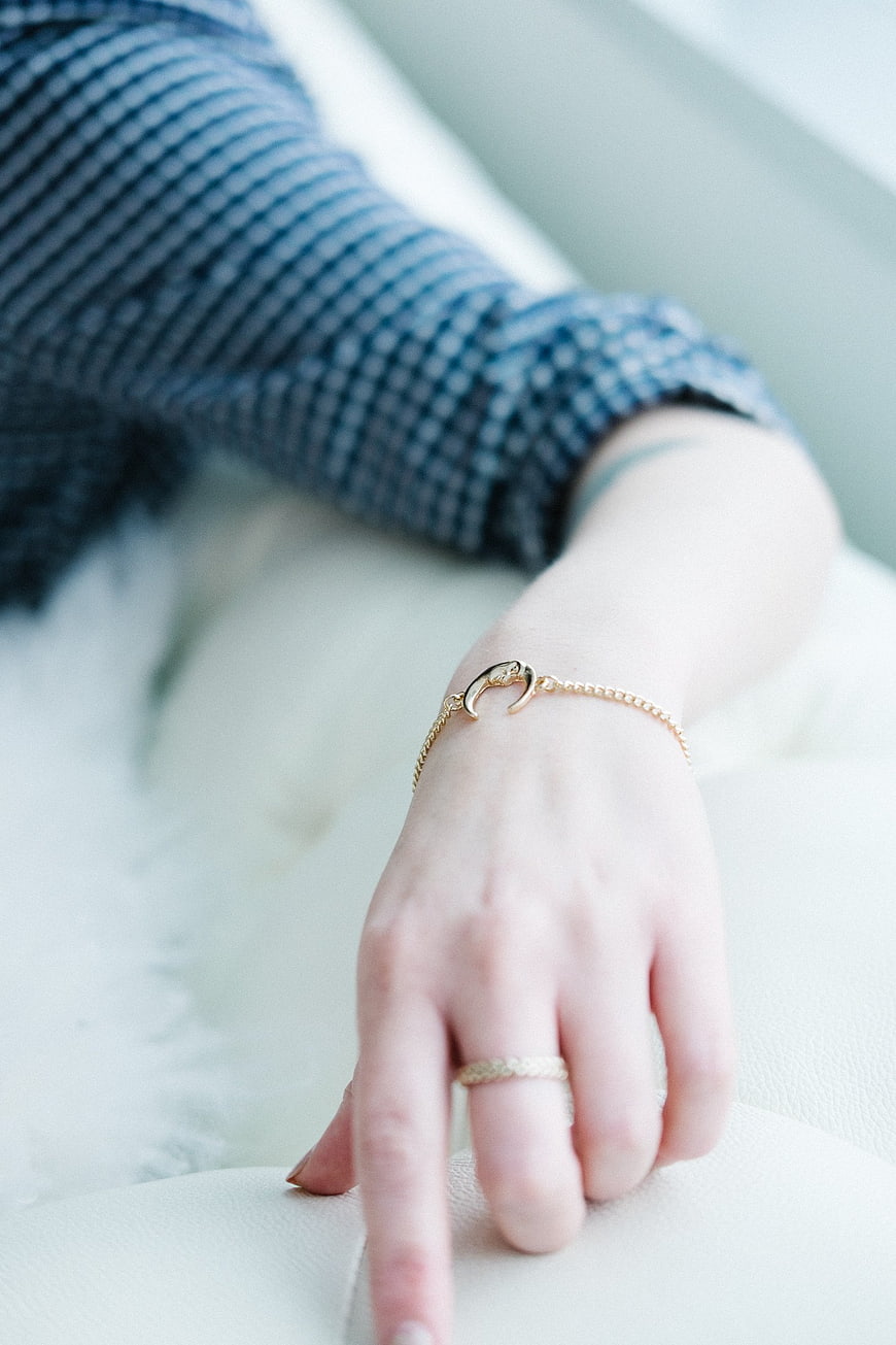 Close-up of Woman's Hand with Gold Bracelet and Ring