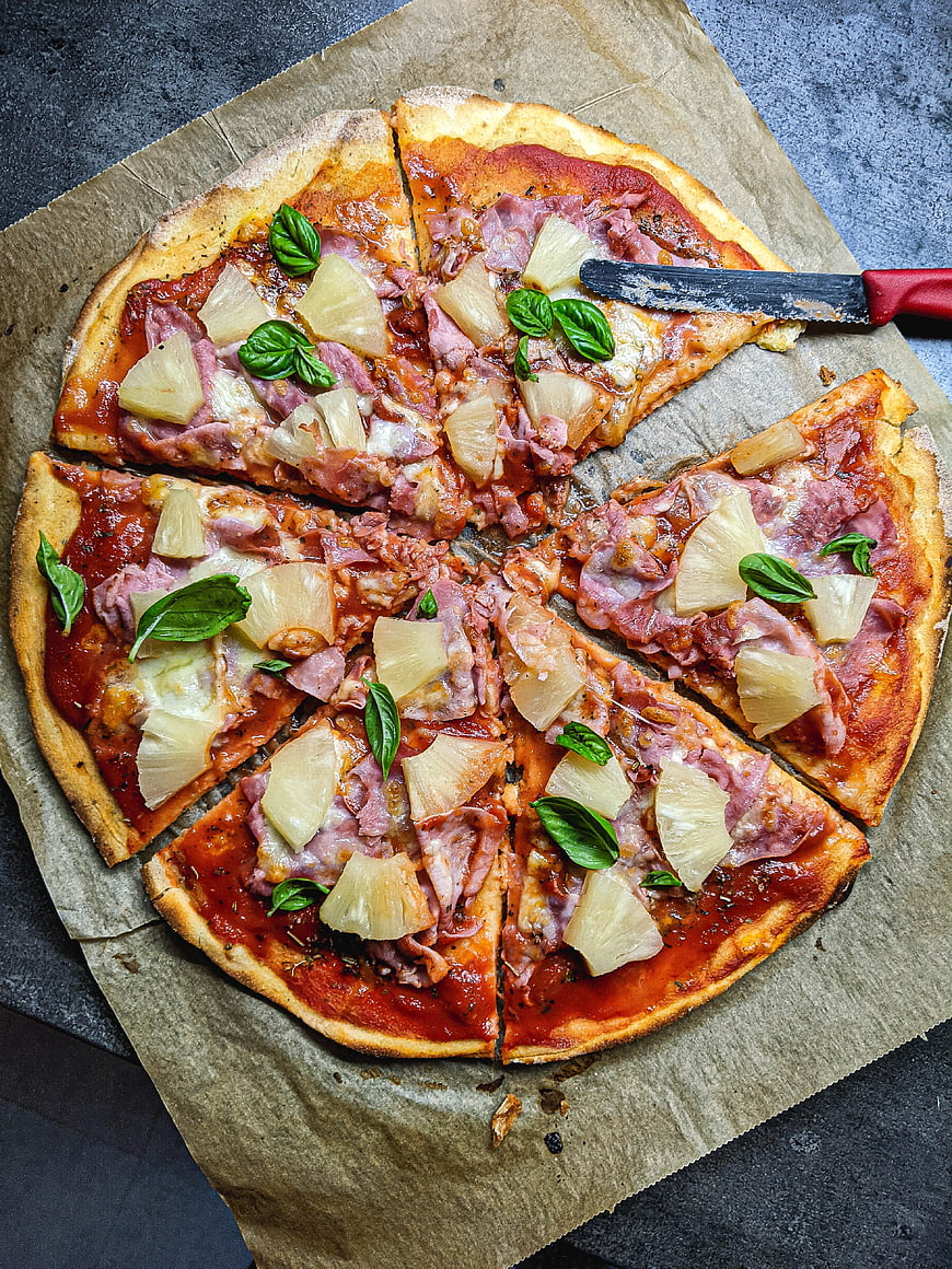 Top view of homemade Hawaiian pizza with pineapple and ham
