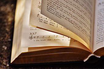 Close-up of open hymnal with German lyrics and sheet music