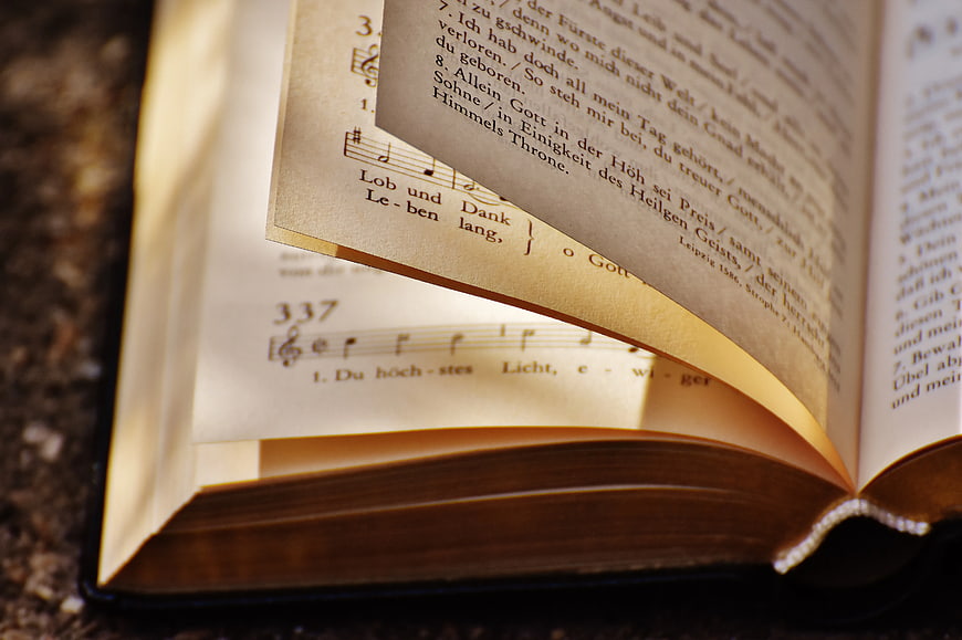 Close-up of open hymnal with German lyrics and sheet music