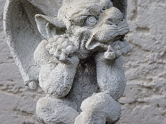 Close-up of weathered stone gargoyle sculpture