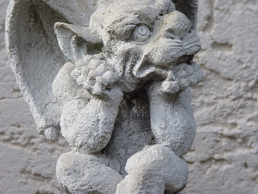 Close-up of weathered stone gargoyle sculpture