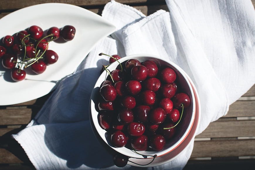 Fresh Red Cherries in White Bowl on Wooden Table