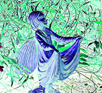 Blue Fairy Statue in Overgrown Garden