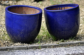 Two Blue Ceramic Planters on Gravel Garden Bed
