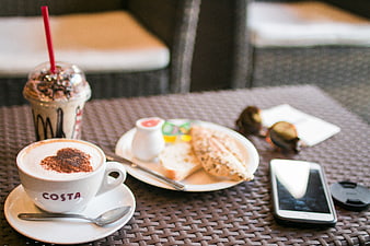 Costa Coffee Latte and Iced Drink with Garlic Bread on Outdoor Table