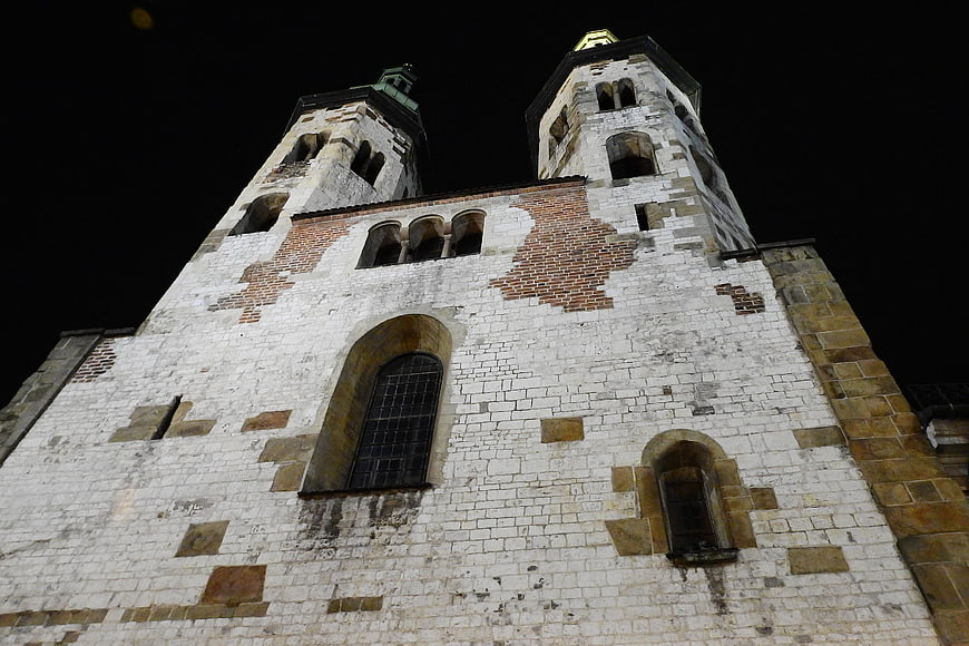 Low angle night view of historic church towers in Krakow