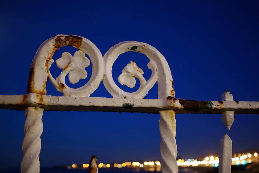 Rusted White Ironwork Against Deep Blue Night Sky