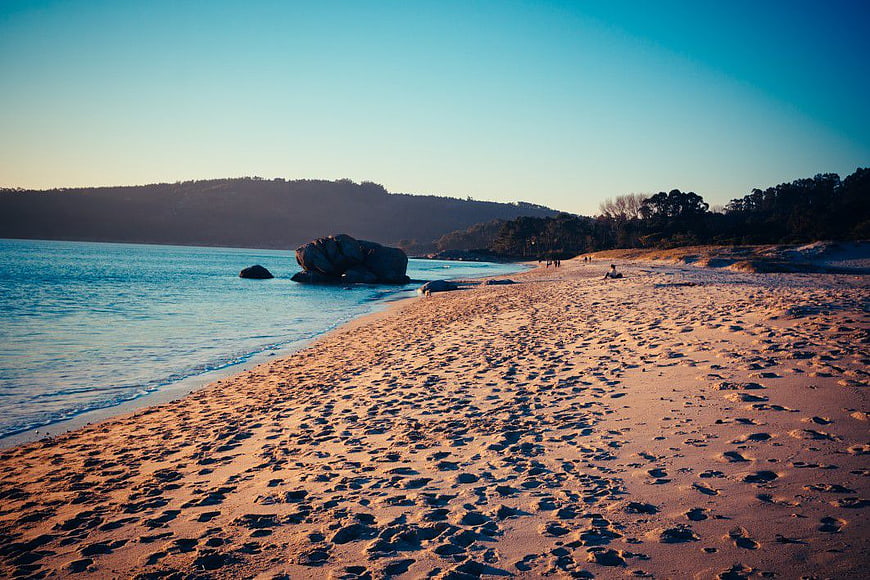Serene Beach at Sunset with Sand and Ocean Waves