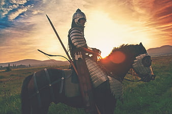 Medieval Knight on Horseback at Sunset in Field
