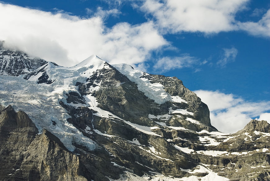 Majestic Snow-Capped Mountain Peak with Blue Sky and Clouds