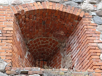 Ancient red brick archway in historic castle ruins