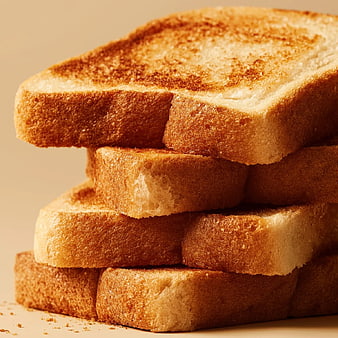 Stack of Golden Brown Toast Slices on Beige Background
