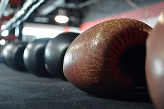Close-up of leather boxing gloves on a dark ring mat