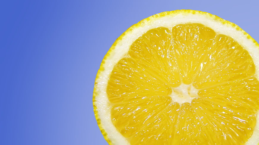 Close-up of Fresh Lemon Slice on Blue Background