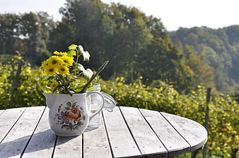 Yellow Chrysanthemums in Vintage Pitcher on Wooden Table