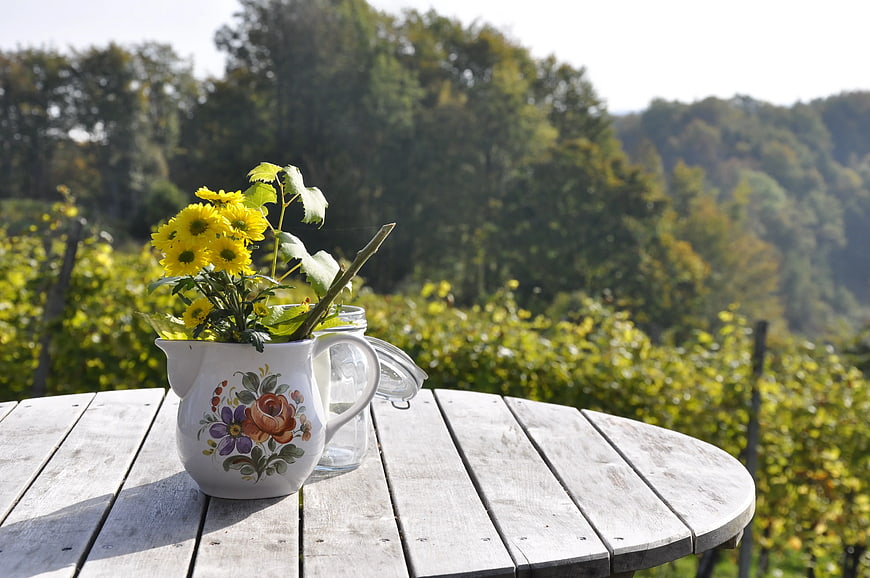 Yellow Chrysanthemums in Vintage Pitcher on Wooden Table