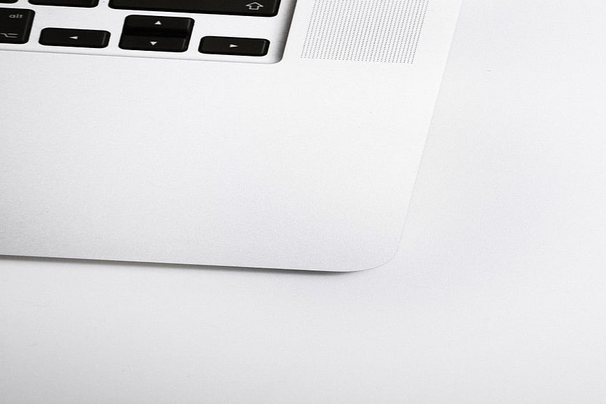 Minimalist White Laptop Corner Close-Up