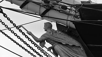 Black and white photo of a ship's figurehead with chains