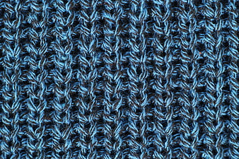 Close-up of blue and black knitted wool sweater texture