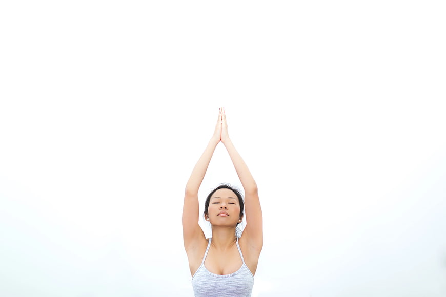 Woman Practicing Yoga with Hands Raised