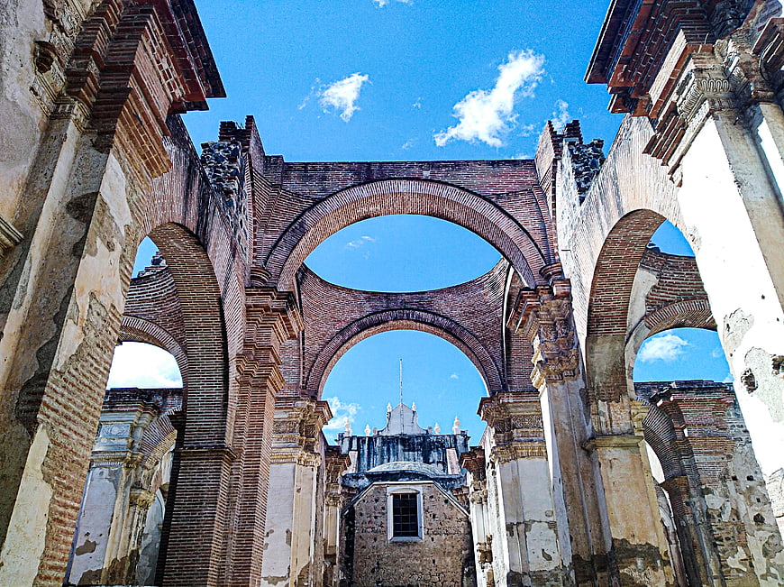 Ruins of a brick church with arches against blue sky