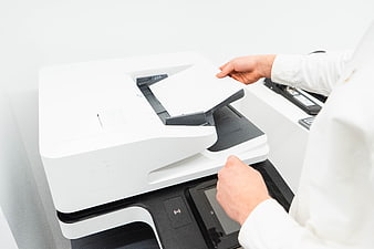 Business person using office printer and copier machine