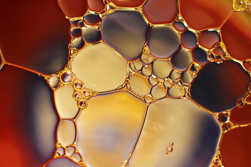 Abstract macro oil and water bubbles in warm amber tones