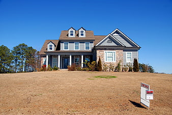 Modern Blue Two-Story House Exterior With For Sale Sign